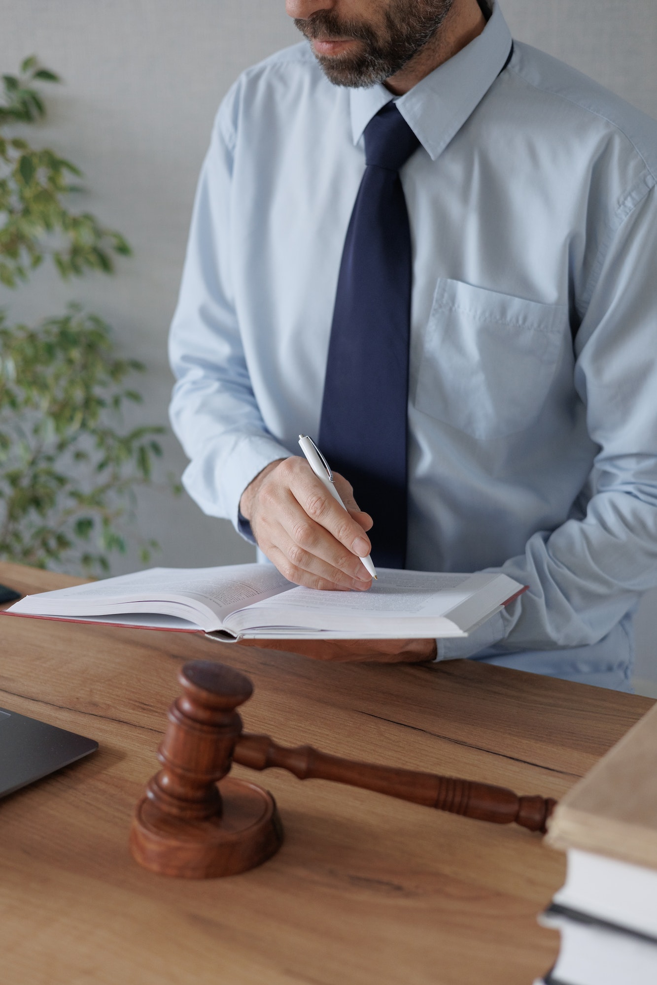 a European male lawyer talks to clients on a webcam from a laptop. work in a law firm or legal