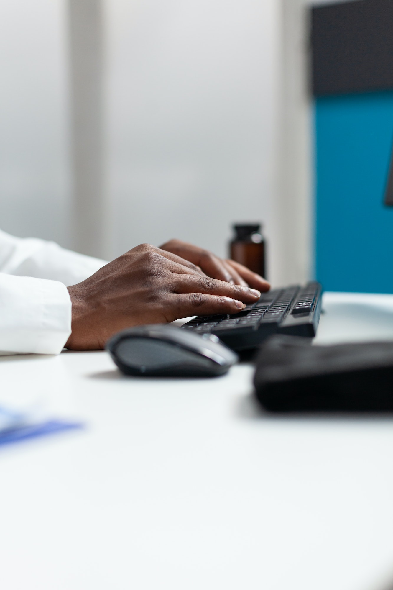 Closeup of african american therapist doctor typing patient healthcare treatment