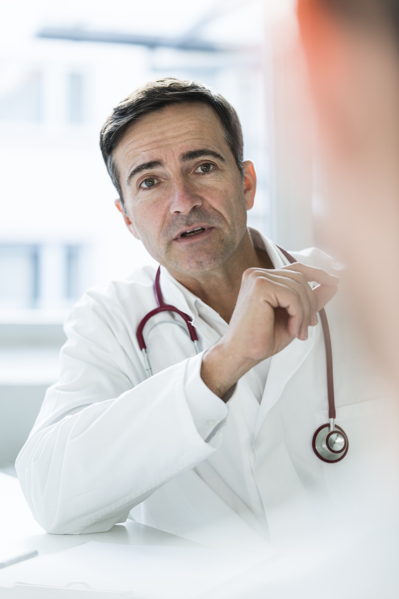Portrait of doctor talking to patient in medical practice
